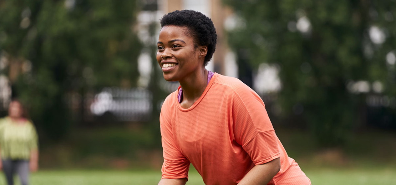 A black women enjoying playing sport in the park