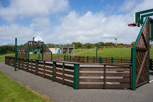 Games court for football, basketball or hockey within a community playground.
