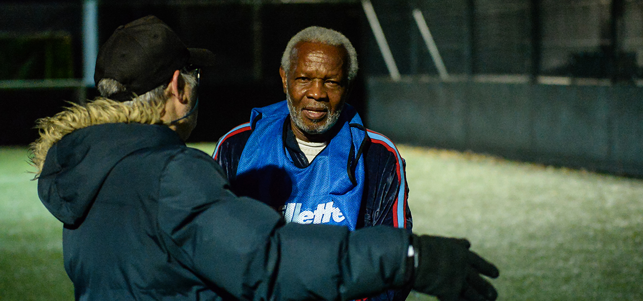 A coach gives instructions at a walking football session.
