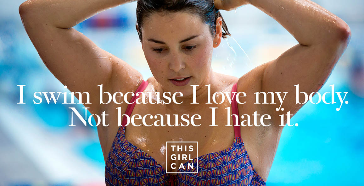 A woman wearing a bikini and dripping water from a swimming pool arranges her hair and the copy "I swim because I love my body. Not because I hate it." appears in white letters over her. Under the copy we can see the This Girl Can logo written in white letters too.