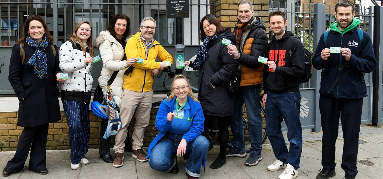 Participants of the Beat the Street programme pose with the cards on the street.  
