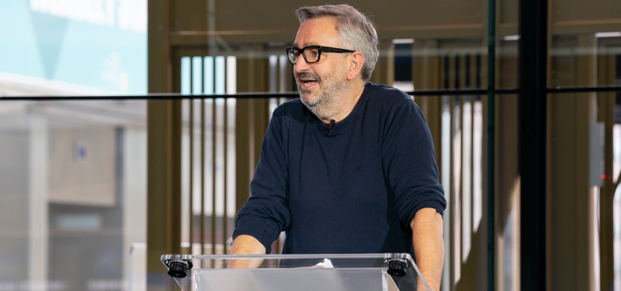 Tim Hollingsworth speaks from a lectern at an event.