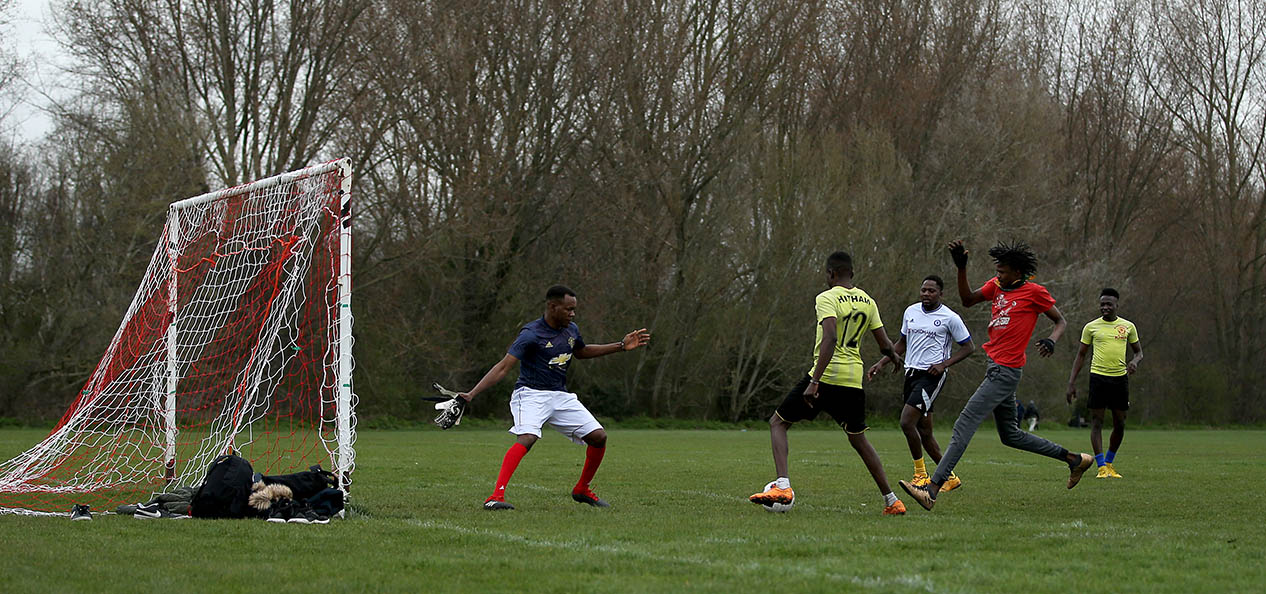 Men playing football in the park