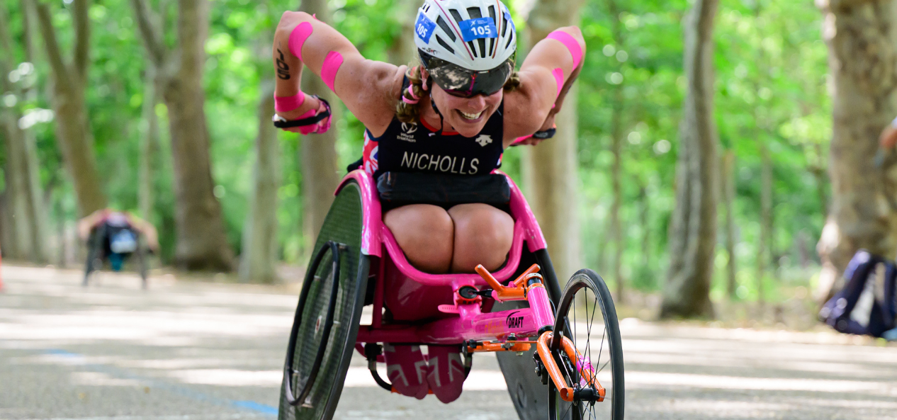 Mel Nicholls, paralympian and member of the UK anti-doping athlete commission member, pushes her chair on a race outdoors. 